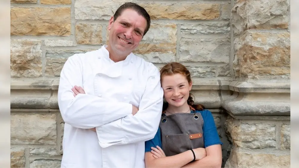 A father and daughter posing for a photo