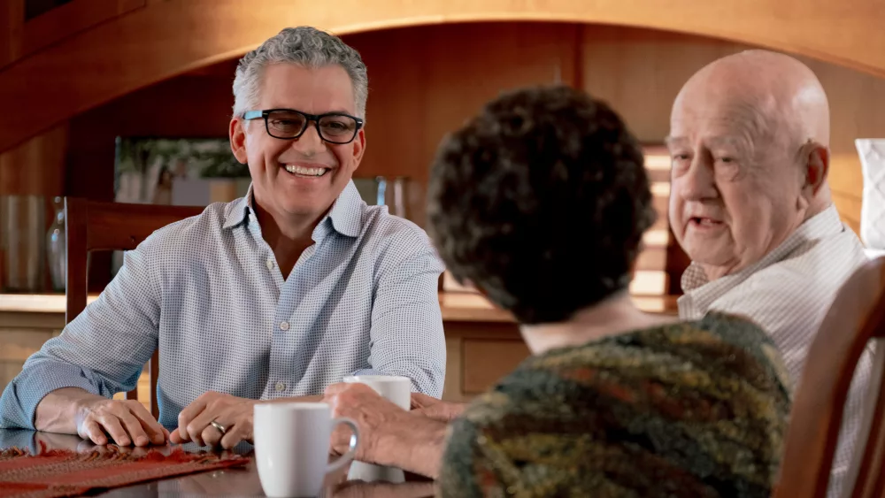 Former U.S. House Candidate for North Dakota Dr. Rick Becker posing for a photo while sitting at a table with constituants