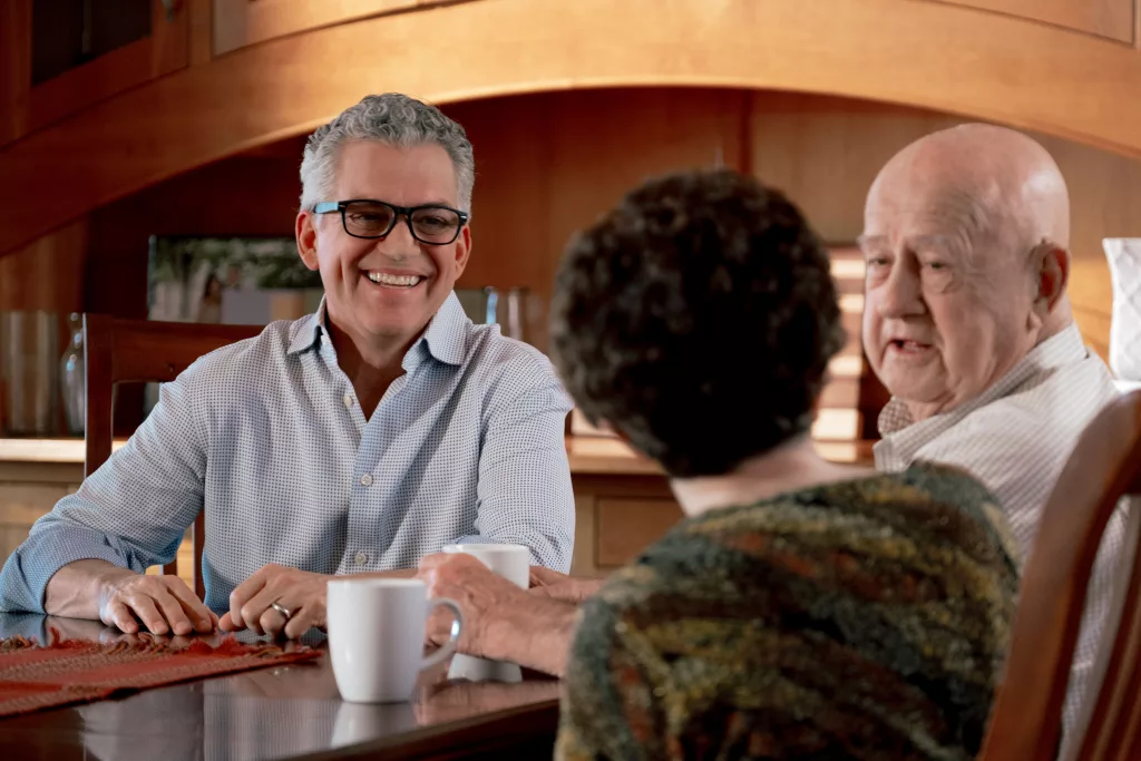 Former U.S. House Candidate for North Dakota Dr. Rick Becker posing for a photo while sitting at a table with constituants