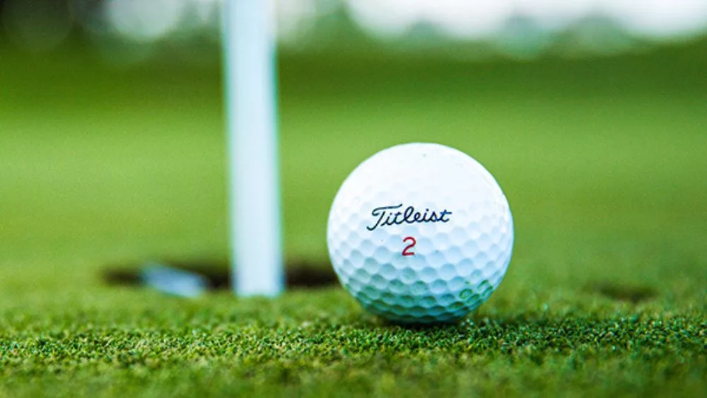 Titleist golf ball near the pin