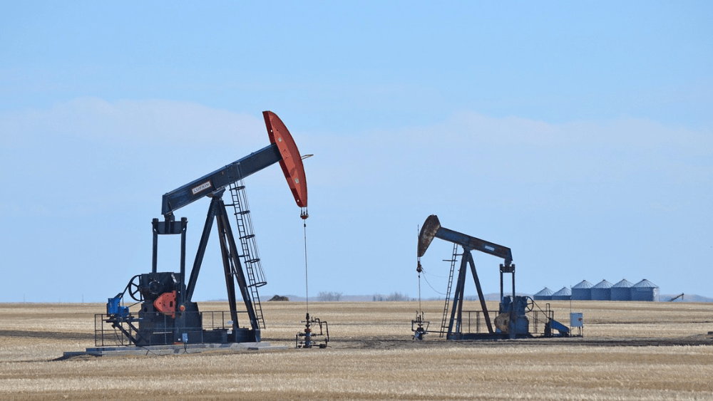 two pumpjacks in an oil field