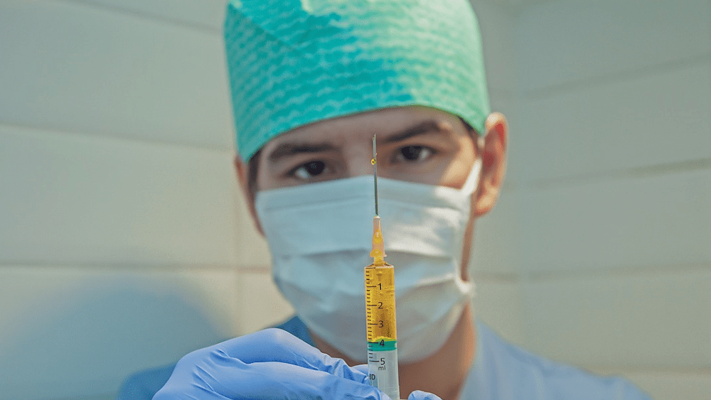 male nurse holding a syringe