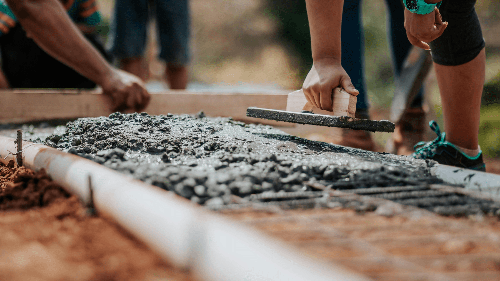 group of workers working laying concrete