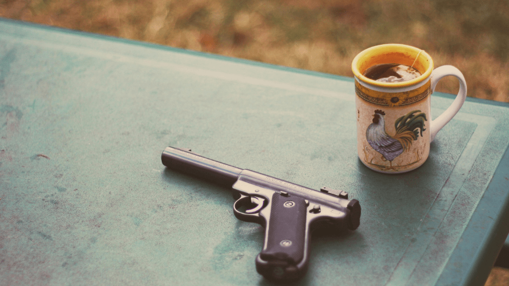 Gun and coffee on a table