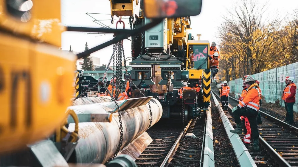 people working on a rail line