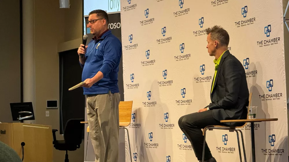 Former Fargo City Commissioner Tony Gerrig (left) speaks to an audience of business members about Measure 4 in North Dakota.