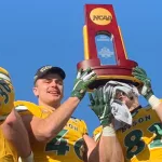 NDSU Football players holding FCS National Championship trophy