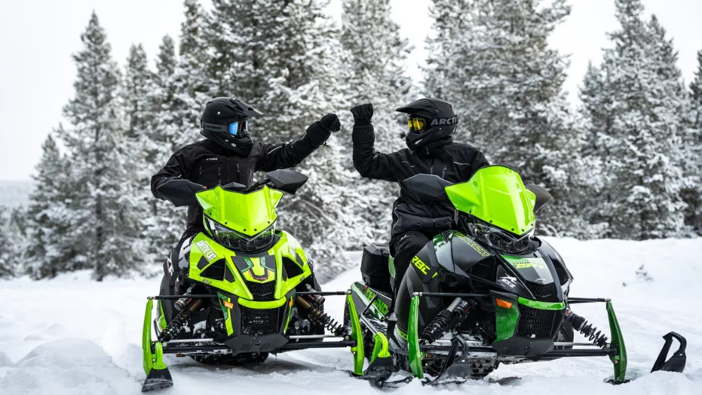 two snowmobiles side by side