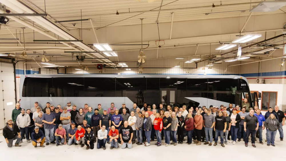 employees in front of a bus