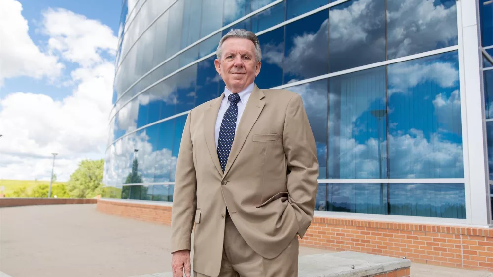 man in front of a building