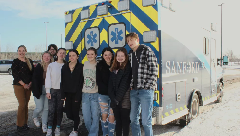 people in front of an ambulance