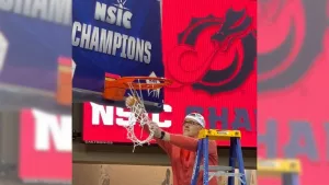 Basketball coach cutting down the net