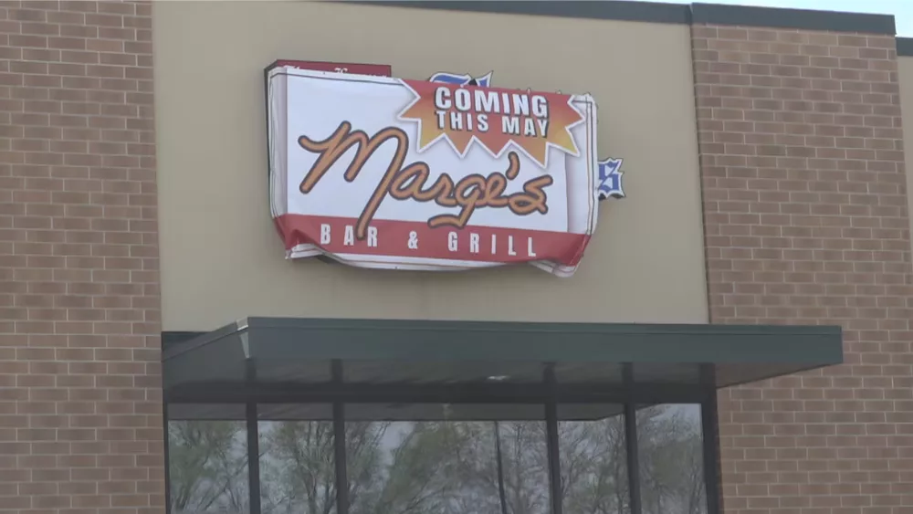 Image of sign above West Fargo storefront that reads "Coming in May. Marge's Bar & Grill"