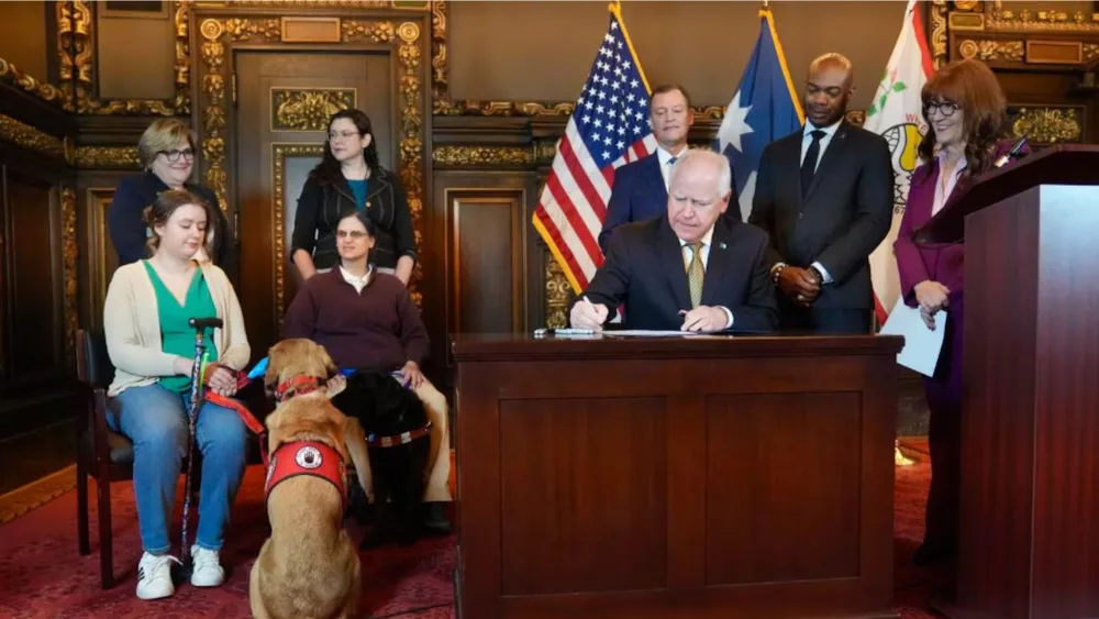 Image of Governor Tim Walz signing legislation