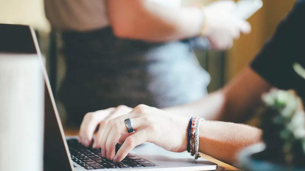 Image of woman typing on a lapto