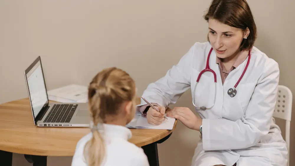 Image of doctor talking to child in office
