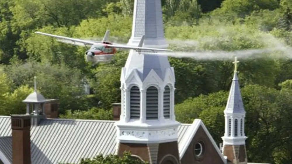 Image of plane conducting aerial bug spraying