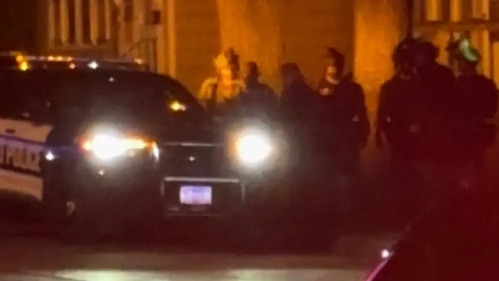 Image of SWAT team walking out with suspect