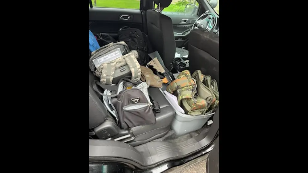 Image of inside of Vance Boelter's car showing guns inside