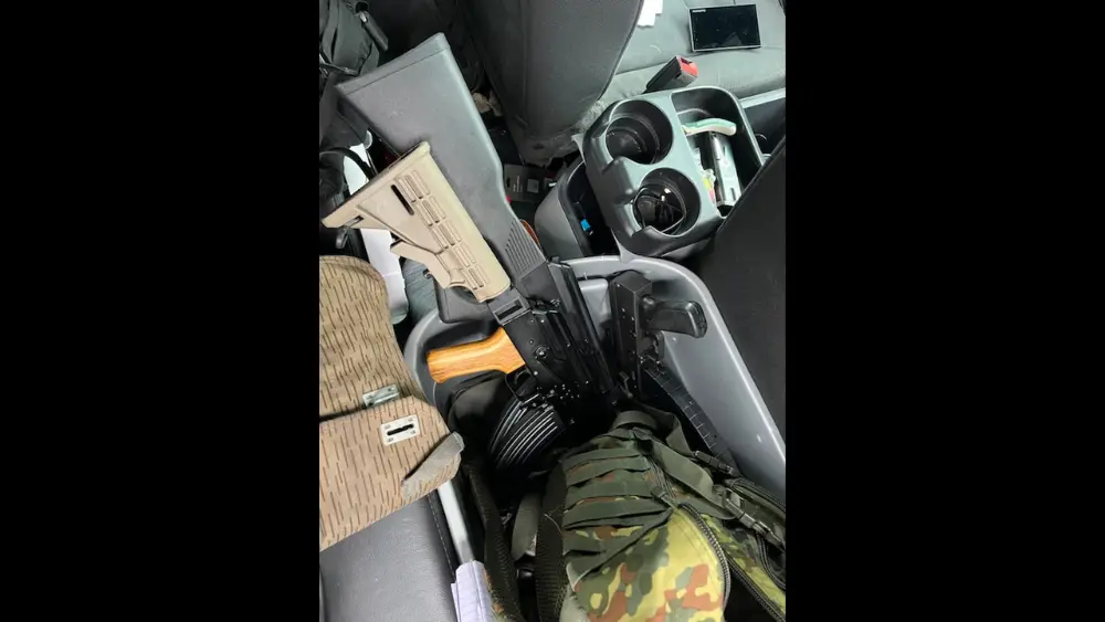 Image of inside of Vance Boelter's car showing guns inside