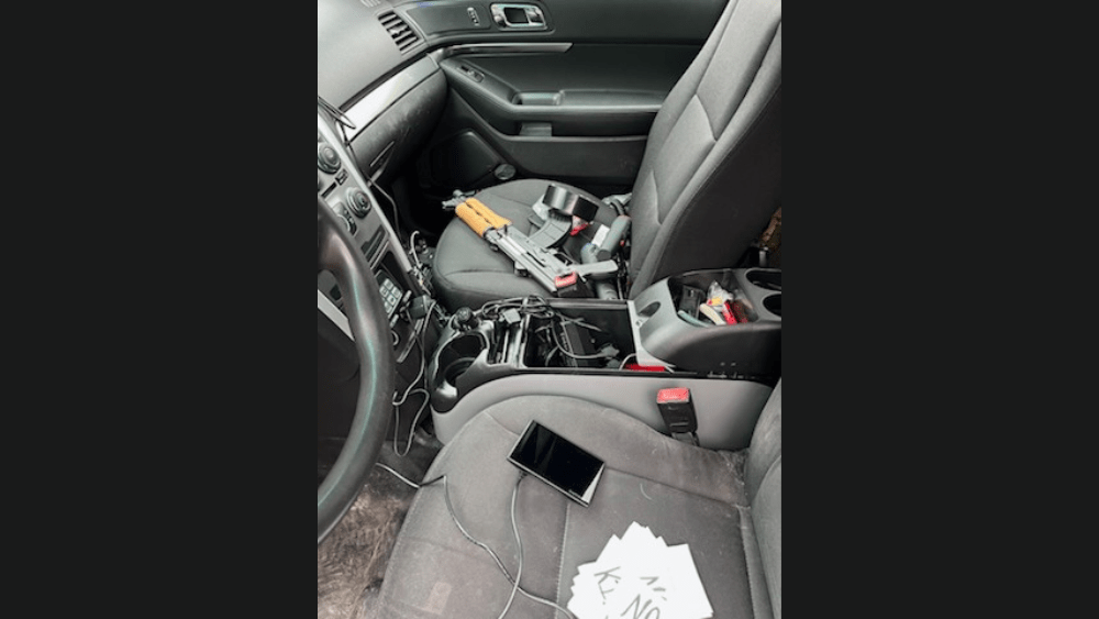 Image of inside of Vance Boelter's car showing guns inside