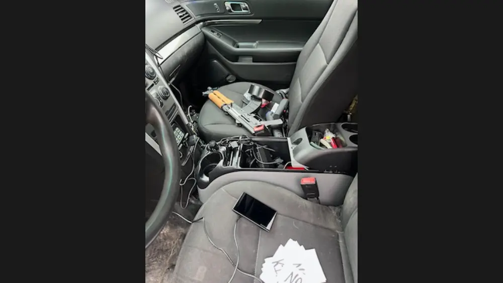 Image of inside of Vance Boelter's car showing guns inside