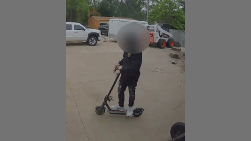 Image of person riding off on a scooter