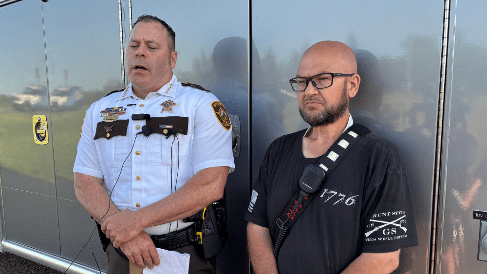 Image of Cass County Sheriff and Enderlin Fire Chief sharing an update on storm damage with the media