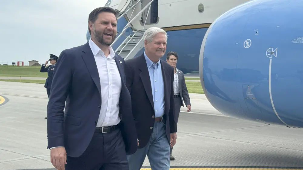 Two men walking from an airplane