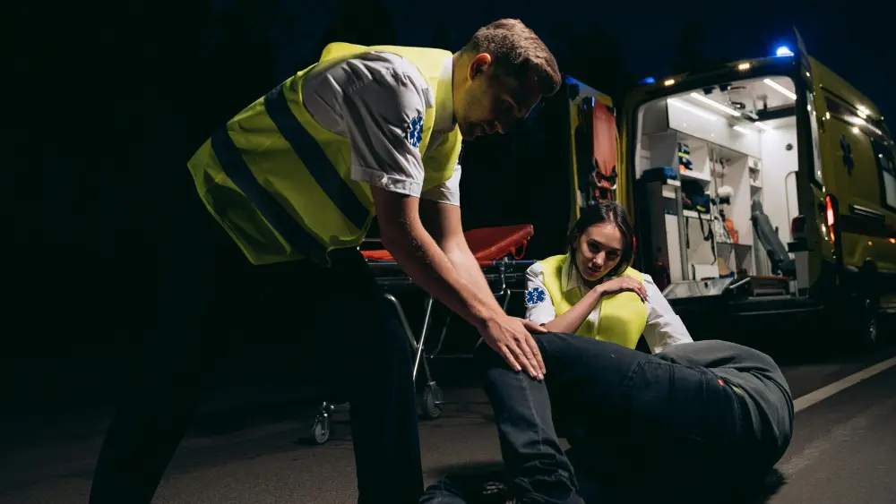 Image of EMTs responding to an injured person on the ground
