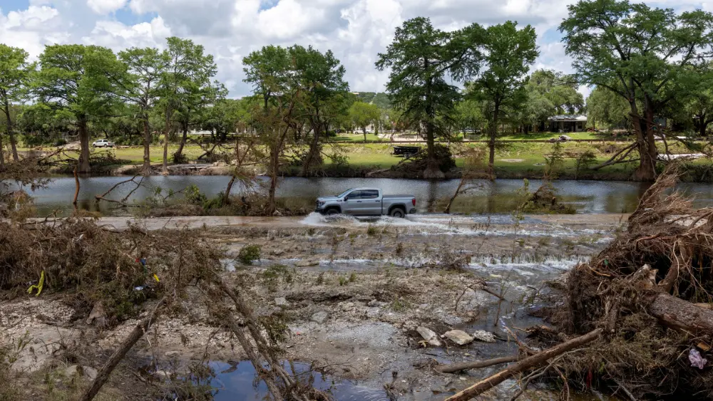 Image of truck driving through Texas flood damage REUTERS