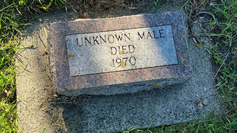 Image of headstone at St. James Cemetery reading "UNKNOWN MALE DIED 1970"