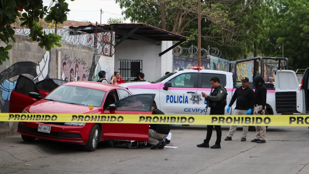 Image of police in Mexico investigating a crime scene related to drug cartel activity
