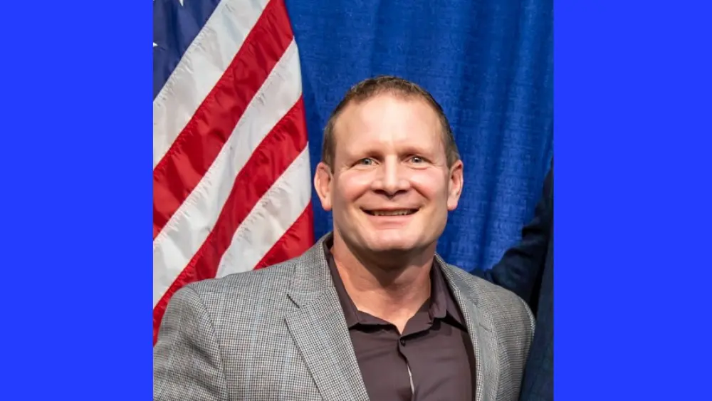 a man in front of a flag