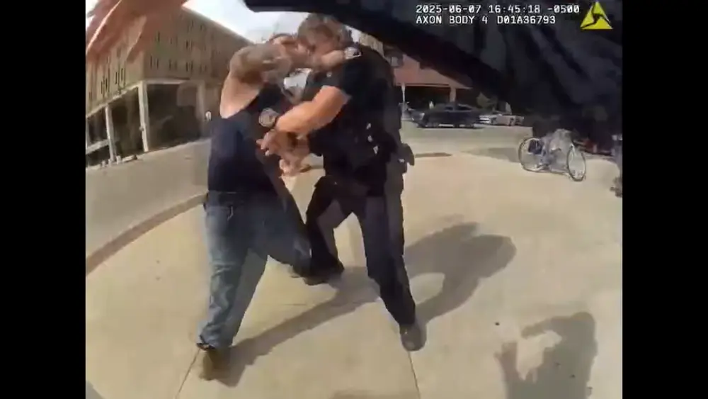 Image of Joseph Manitowabi striking one of the officers