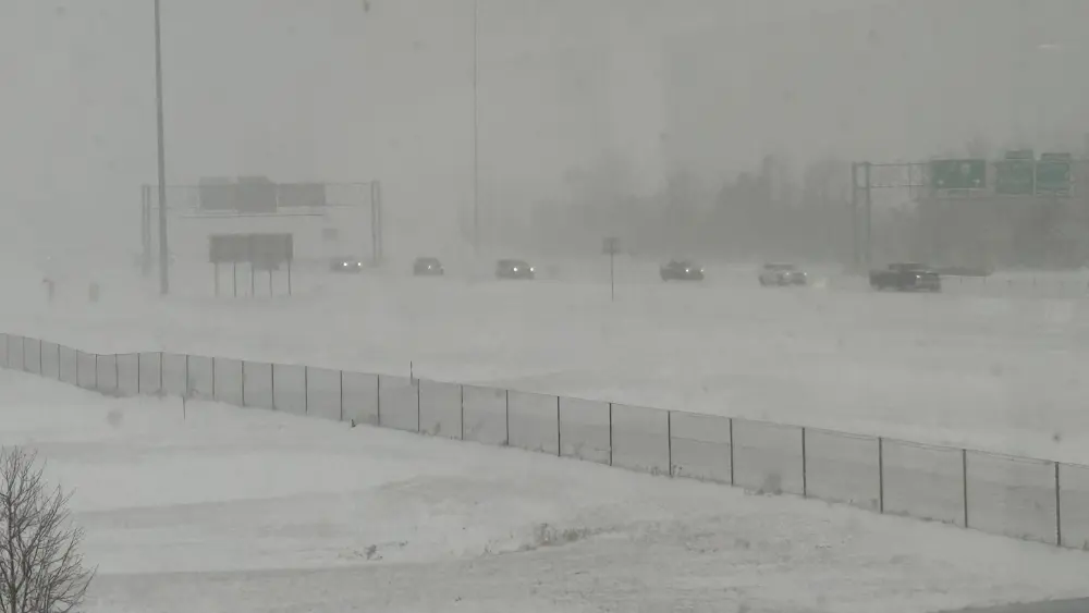 Vehicles dealing with snowy conditions on Interstate 29