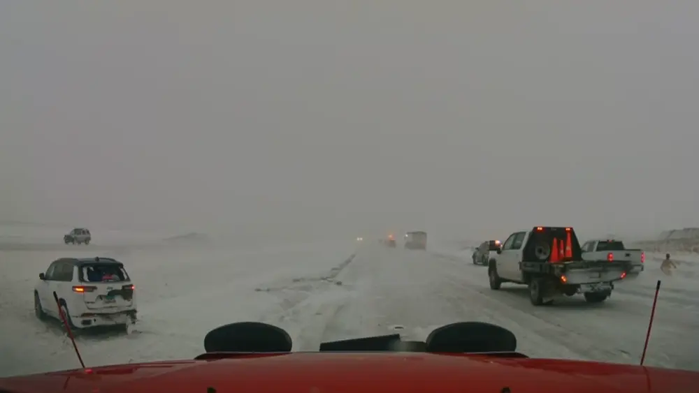 A pickup drives through a scene