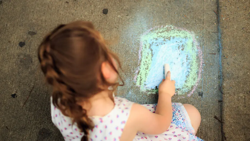 A child drawing with chalk