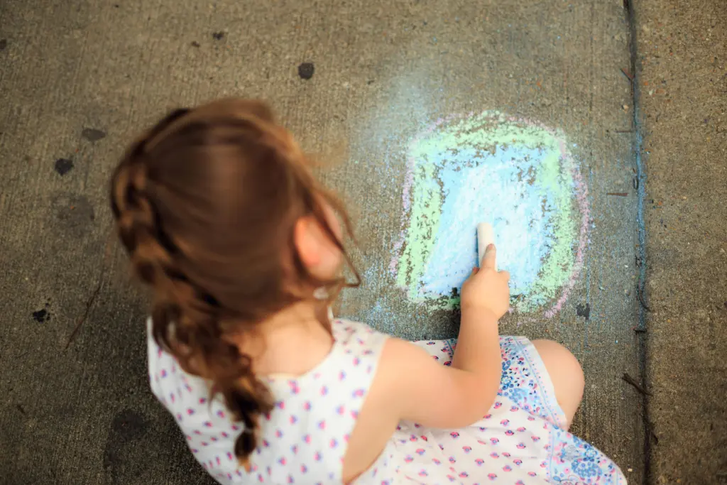 A child drawing with chalk