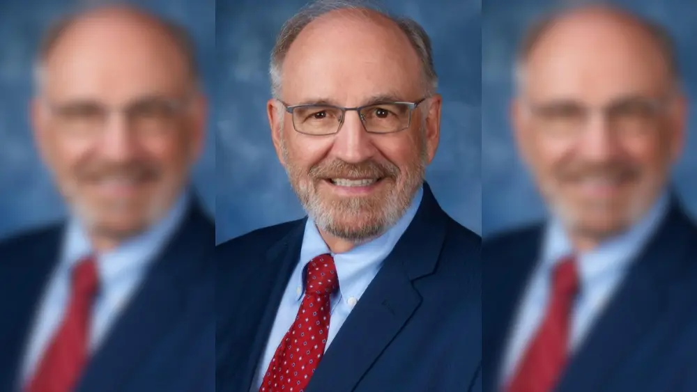 man in front of a blue background
