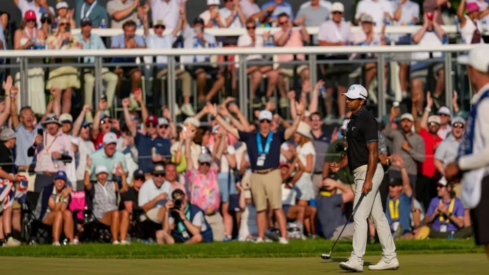 Golfer Aaron Rai celebrating making a 68 foot putt