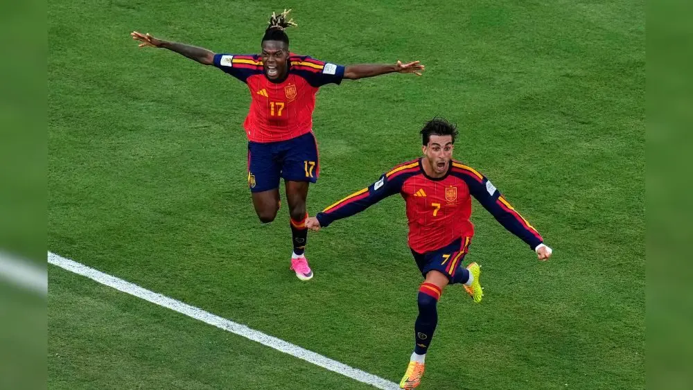 2 soccer players from Spain celebrating a scored goal in the 2026 World Cup final