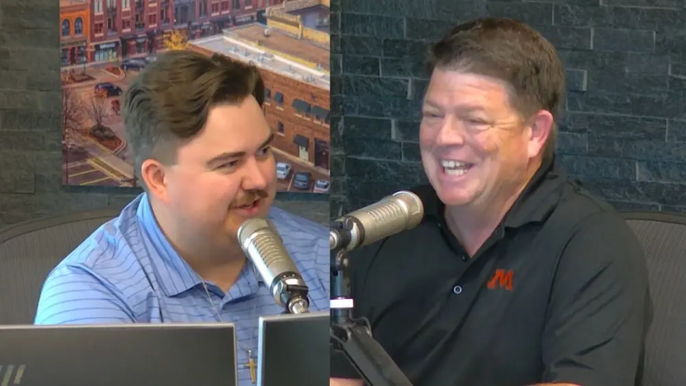 James McCarty having a conversation with New Moorhead Spuds Football play-by-play broadcaster Jim Childs