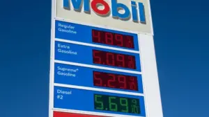 Mobil gas station sign showing high price of California Gasoline with bright blue sky Lone Pine^ CA^ USA - February 9th^ 2023