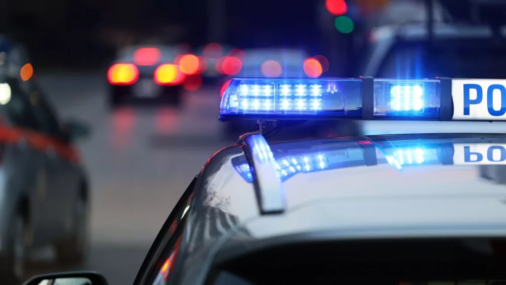 police patrol car with blue flashing light on the roof of the police car.