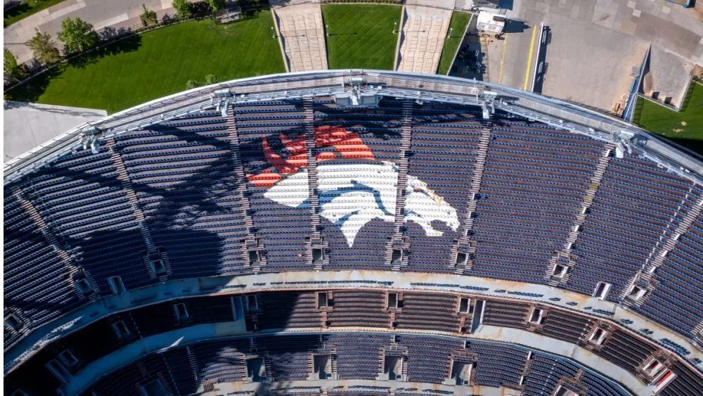 Denver Broncos Logo in Empty Stadium Seats at Empower Field. Aerial Top-Down View of NFL Branding and Architecture in Denver^ Colorado ay 26^ 2022 Denver^ Colorado