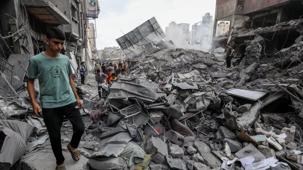 People search the Khan Yunis municipality building after an Israeli air strike^ in the city of Khan Yunis^ southern of the Gaza Strip^ October 10^ 2023.