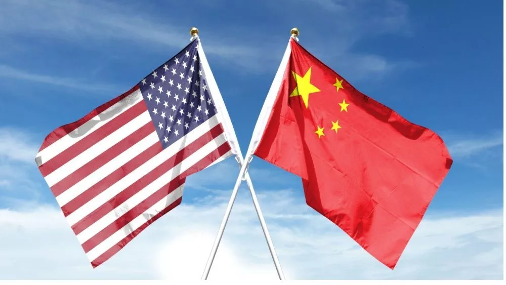 American and Chinese flags on cloudy sky. waving in the sky