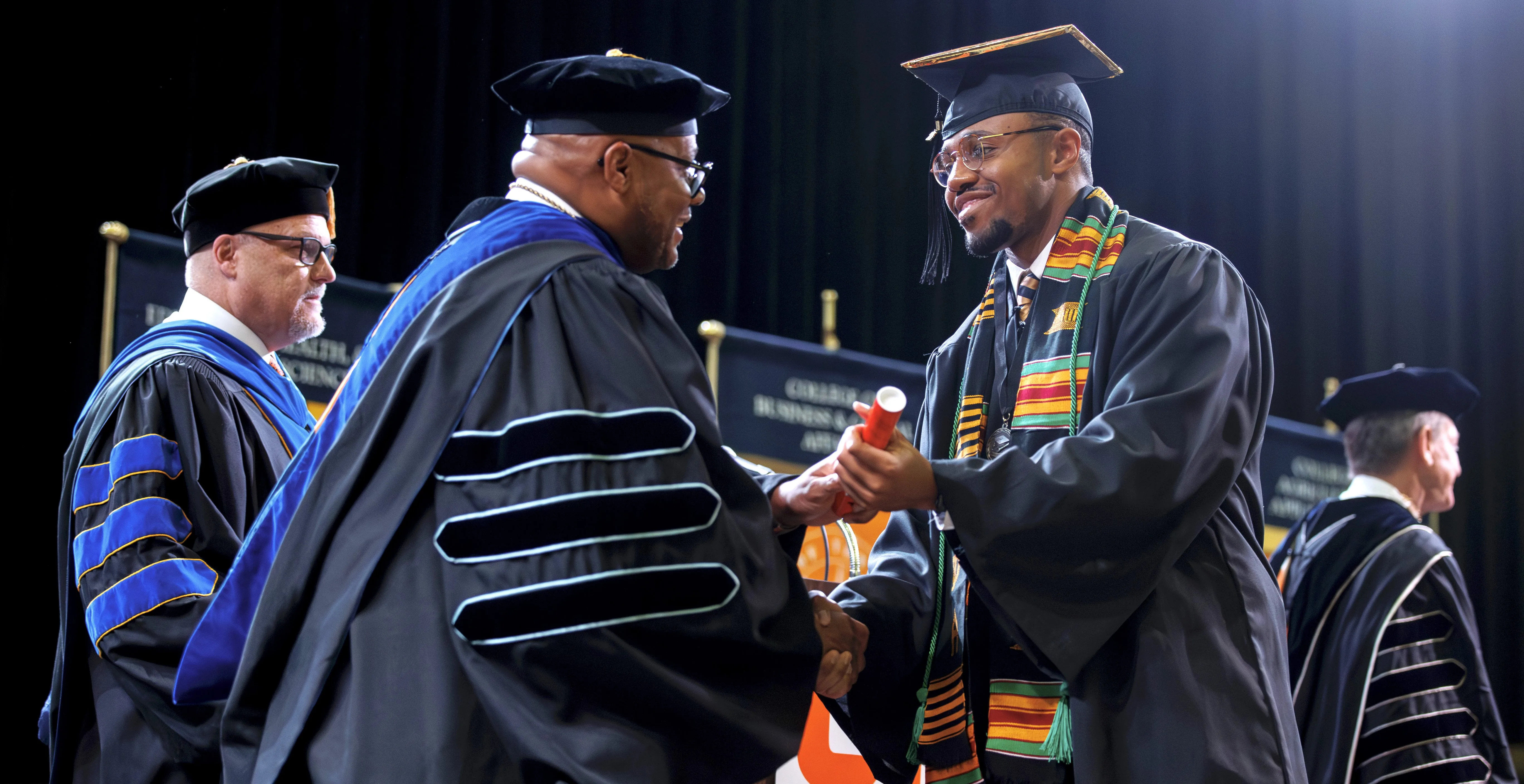 utm-shuan-harris-with-diploma
