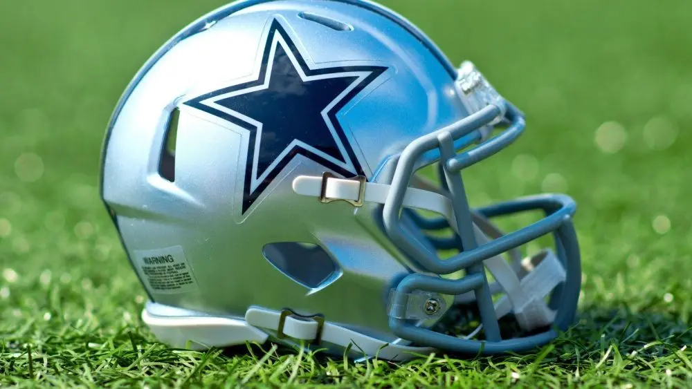 NFL Dallas Cowboys replica helmet on artificial grass playing turf ^ product shot